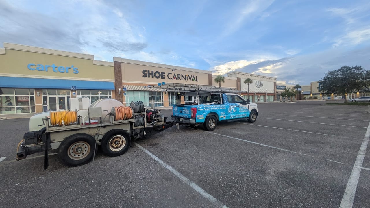 Jacobs Pressure Cleaning truck and trailer rig staged at Hammock Landing shopping plaza in Palm Bay, FL