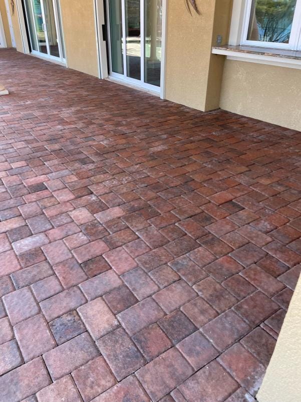 Faded, darkened brick pavers before cleaning and color restoration at a Rockledge, FL estate