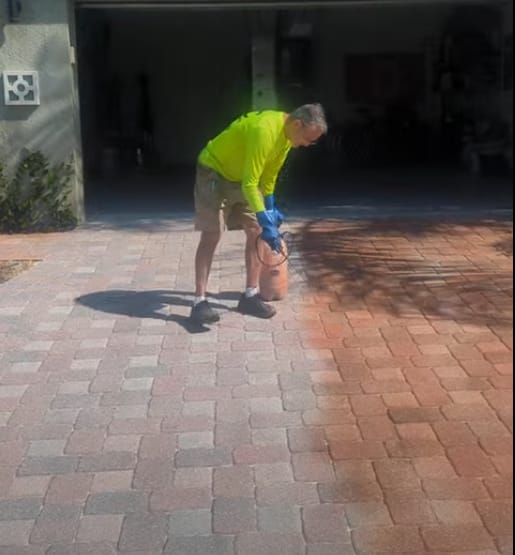 JPC technician applying penetrating paver tint by hand to restore terra cotta color in Rockledge, FL