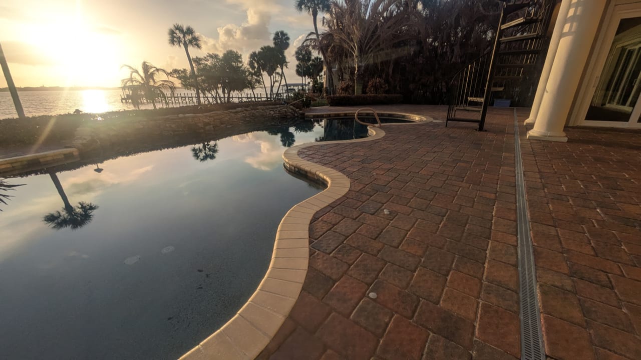 Sealed brick pavers along the pool edge at a riverfront home in Rockledge, FL