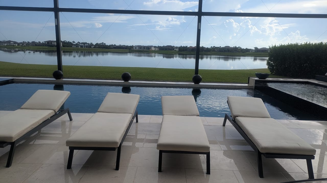 Screened pool deck overlooking the lake at a Viera, FL estate after a soft wash visit