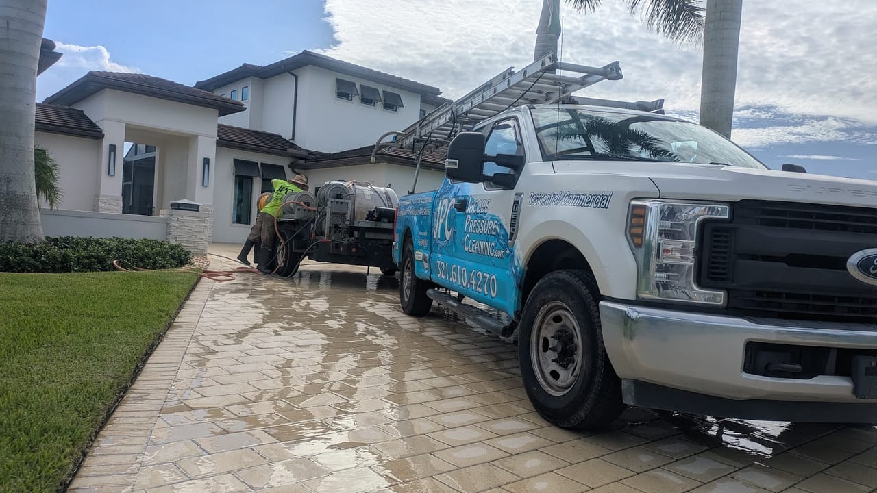 JPC truck and wash trailer parked on the freshly cleaned paver driveway of a Viera, FL lakefront estate